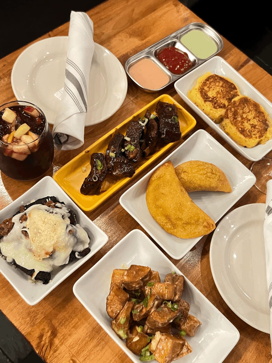 Small plates and a glass of sangria on a wooden table at D'Antigua