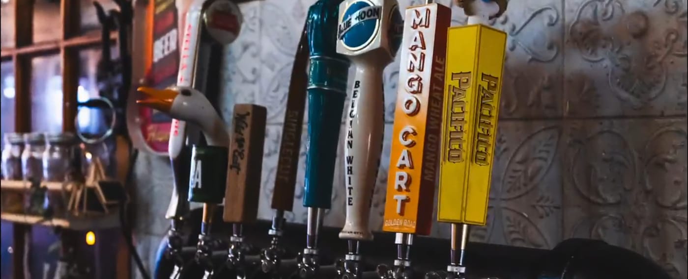 Beer tap handles lined up behind the bar at D'Antigua